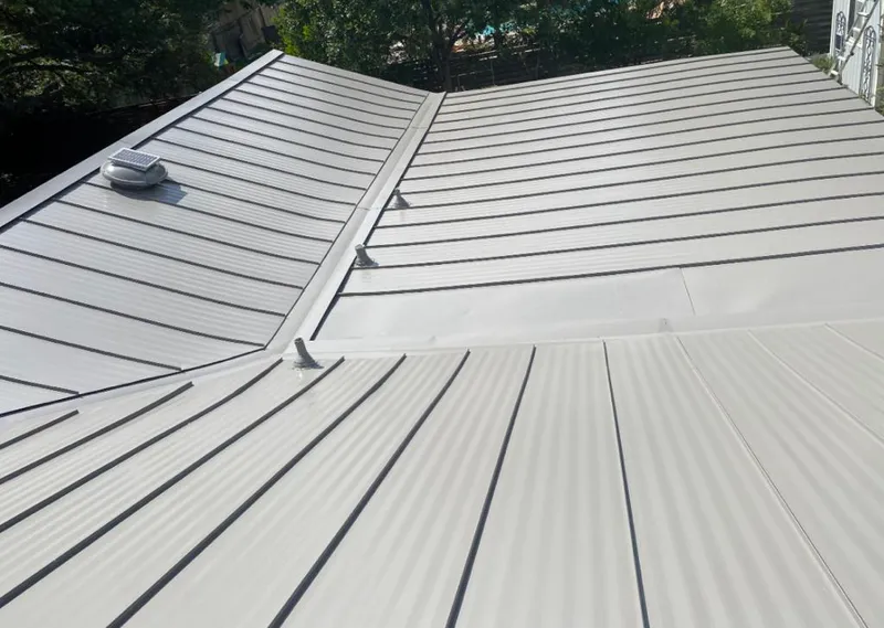 Solar attic fan installed on a metal roof for Roof Ventilation in Stone Mountain